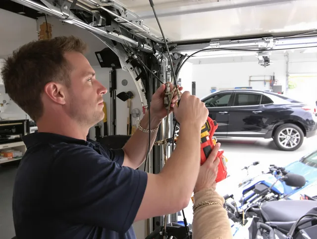 Westport Garage Door Repair safety certified technician performing cable replacement in Westport